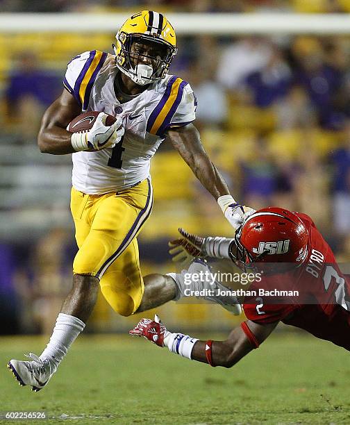 Nick Brossette of the LSU Tigers runs with the ball as Daniel Byrd of the Jacksonville State Gamecocks defends during the second half of a game at...