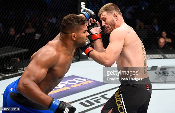 Alistair Overeem of The Netherlands punches Stipe Miocic in their UFC heavyweight championship bout during the UFC 203 event at Quicken Loans Arena...