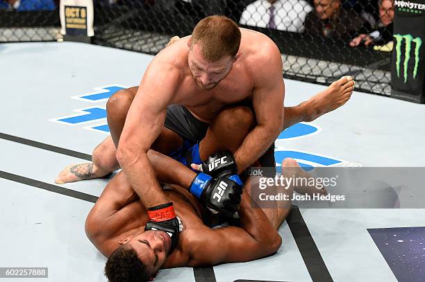 Stipe Miocic punches Alistair Overeem of The Netherlands in their UFC heavyweight championship bout during the UFC 203 event at Quicken Loans Arena...