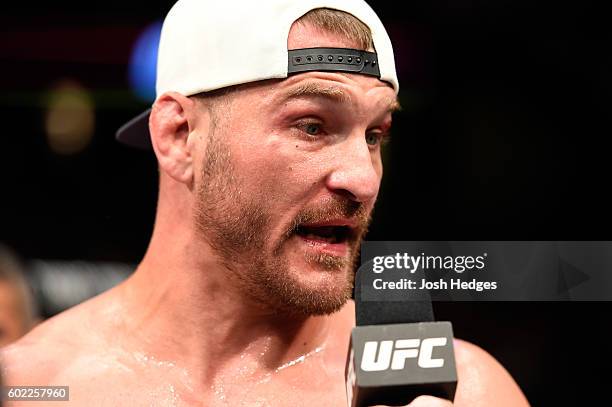 Stipe Miocic speaks with Joe Rogan after defeating Alistair Overeem of The Netherlands in their UFC heavyweight championship bout during the UFC 203...
