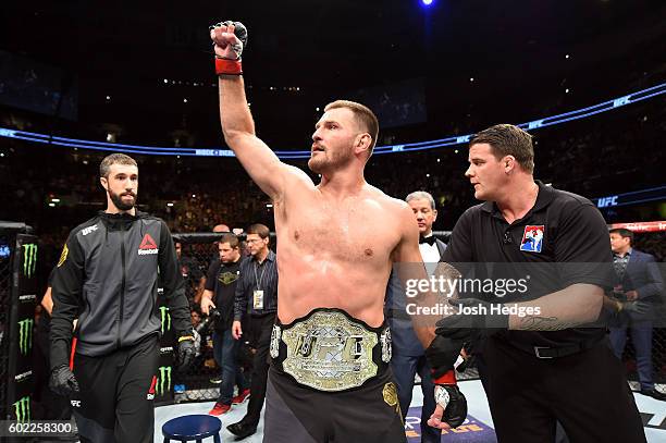 Heavyweight champion Stipe Miocic celebrates after defeating Alistair Overeem of The Netherlands in their UFC heavyweight championship bout during...