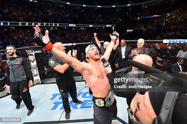 Heavyweight champion Stipe Miocic celebrates after defeating Alistair Overeem of The Netherlands in their UFC heavyweight championship bout during...