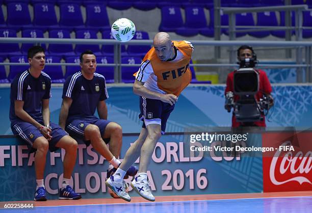Damian Stazzone of Argentina heads the ball as head coach Diego Giustozzi, second from left, looks on during training prior to the FIFA Futsal World...