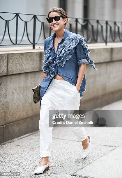 Guest is seen outside the Jonathan Simkhai show wearing a jeans top and white pants during New York Fashion Week Spring 2017 on September 10, 2016 in...