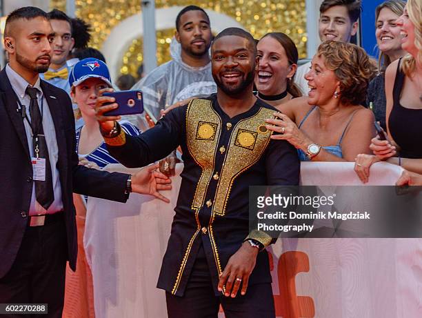 Actor David Oyelowo poses with fans at the 'Queen of Katwe' premiere during the 2016 Toronto International Film Festival at the Roy Thomson Hall on...