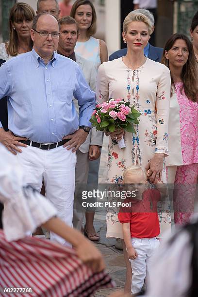 Prince Albert II of Monaco, Prince Jacques, Princess Charlene of Monaco are welcomed by dancers wearing traditional costumes during the annual...