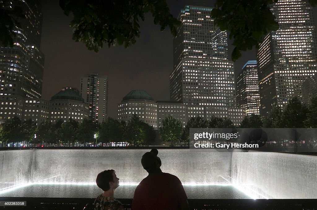 People look up at One World Trade Center from the national 9/11 Memorial in advance of the 15th anniversay of the 9/11 attacks on the World Trade Center...