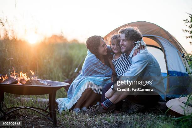 little girl camping with her parents - camping family stock pictures, royalty-free photos & images