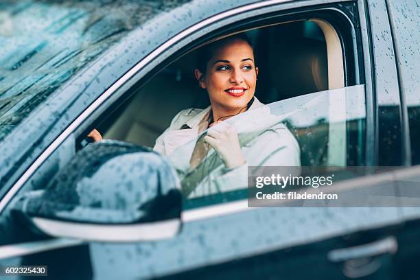 woman driving - driving rain stock pictures, royalty-free photos & images