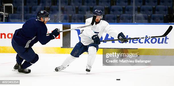 Tomas Tatar and Jannik Hansen battle for the puck during a practice at the Centre Videotron on September 7, 2016 in Quebec City, Quebec, Canada.