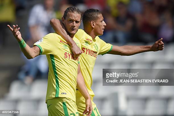 Nantes' Belgian midfielder Guillaume Gillet and Nantes' French forward Yacine Bammou react as a goal is refused by the referee during the French L1...