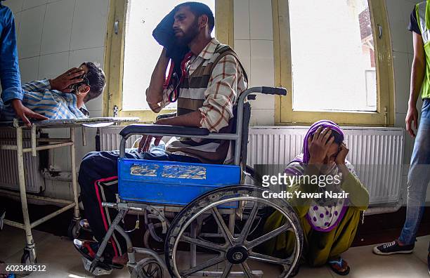 Wounded Kashmir Muslims wait in a hospital room to receive treatment form doctors after Indian government forces fired bullets and pellets at them in...