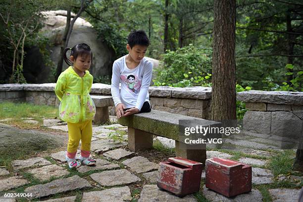 Legless teenager Gao Zhiyu rests during climbing on the Mount Lao on September 10, 2016 in Qingdao, Shandong Province of China. 11-year-old Gao Zhiyu...