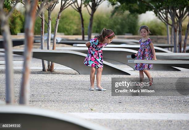 Two young girls visit the Pentagon's 911 Memorial Park, on September 11, 2016 in Arlington, Virginia. President Obama is scheduled to visit the...