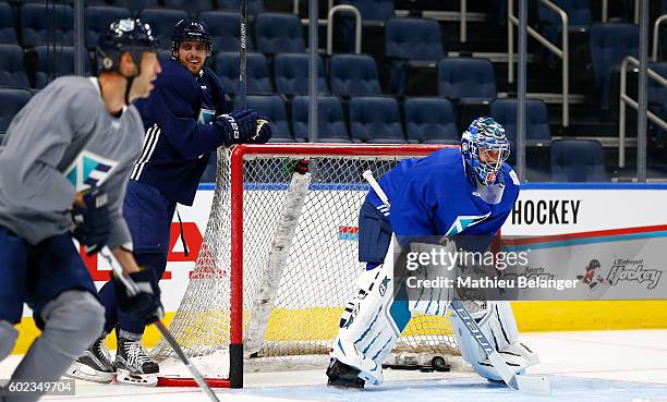 Anze Kopitar smiles while goalie Jaroslav Halak of Team Europe waits for a shot during a practice at the Centre Videotron on September 7, 2016 in...