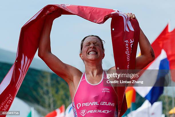 Holly Lawrence of Great Britain celebrates after crossing the finish line during the 2016 Beijing International Triathlon at Beijing Garden Expo on...