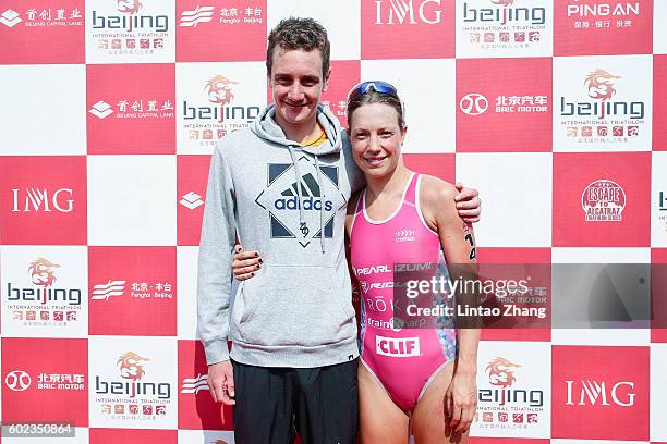 Alistair Brownlee and Holly Lawrence of Great Britain celebrate after crossing the finish line during the 2016 Beijing International Triathlon at...