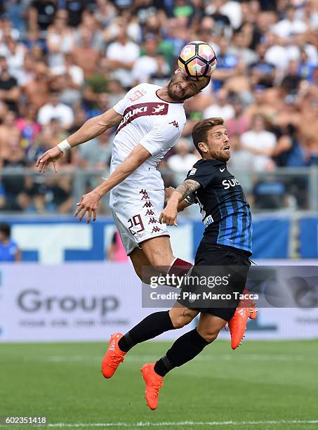 Lorenzo De Silvestri of FC Torino co mpetes for the ball with Alejandro Gomez of Atalanta BCduring the Serie A match between Atalanta BC and FC...