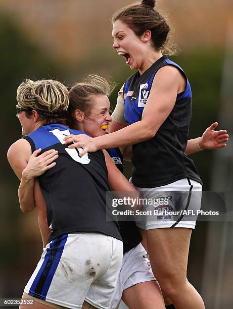 Alicia Eva of Melbourne Uni is congratulated by Ellie Blackburn and Catherine O'Bryan after kicking a goal during the Women's VFL Preliminary Final...