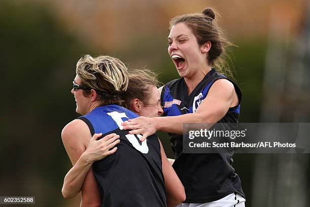 Alicia Eva of Melbourne Uni is congratulated by Ellie Blackburn and Catherine O'Bryan after kicking a goal during the Women's VFL Preliminary Final...