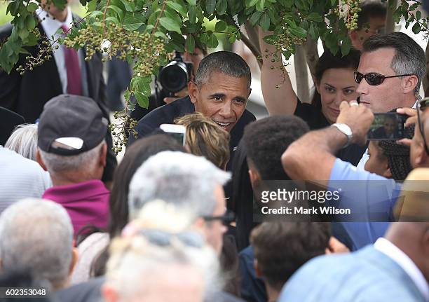President Barack Obama ducks under a tree to greet people after a ceremony to mark the 15th anniversary of the 9/11 terrorists attacks at the...