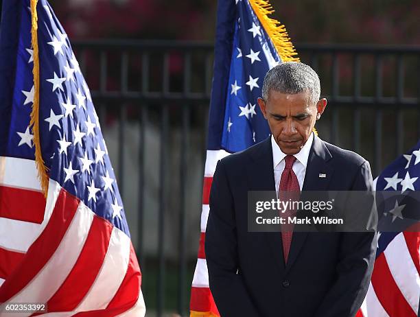 President Barack Obama participates in a moment of silence during a ceremony to mark the 15th anniversary of the 9/11 terrorists attacks at the...