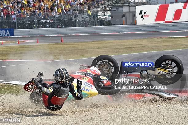 Team Moto2 Spanish rider Alex Pons falls with QMMF Racing team Belgiqn rider Xavier Simeon during the Moto2 race of the San Marino Moto GP Grand Prix...