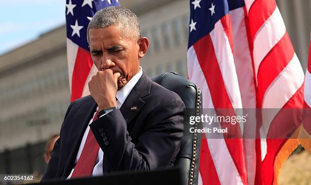 President Barack Obama participates in a moment of silence during a ceremony to mark the 15th anniversary of the 9/11 terrorists attacks at the...