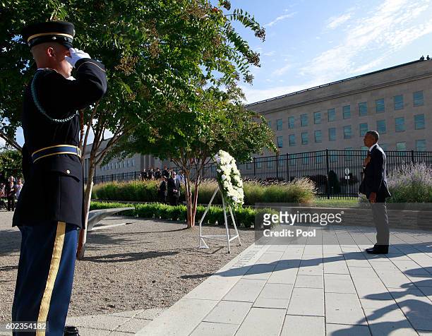 President Barack Obama pauses during a ceremony to mark the 15th anniversary of the 9/11 terrorists attacks at the Pentagon Memorial September 11,...