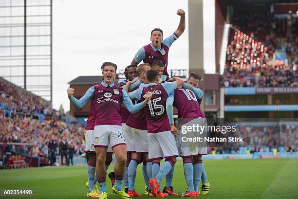 Jack Grealish and Tommy Elphick of Aston Villa celebrate their teams second goal during the Sky Bet Championship match between Aston Villa and...