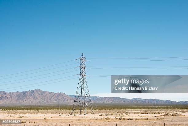 power lines in the desert with mountains - hannah bichay stock pictures, royalty-free photos & images