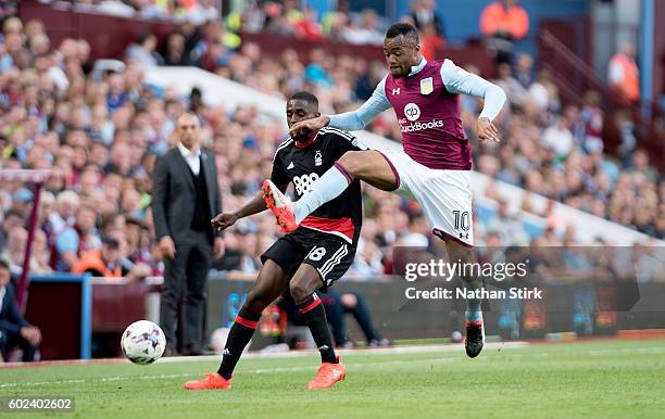 Jordan Ayew of Aston Villa and Mustapha Carayol of Nottingham Forest in action during the Sky Bet Championship match between Aston Villa and...