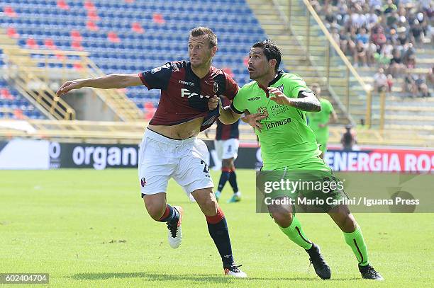 Marco Borriello of Cagliari Calcio competes the ball with Daniele Gastaldello of Bologna FC during the Serie a match between Bologna FC and Cagliari...
