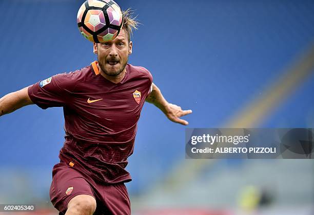 Roma's Italian forward Francesco Totti heads the ball during the Italian Serie A football match between AS Roma and Sampdoria on September 11, 2016...