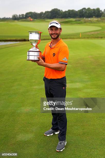 Joost Luiten of the Netherlands celebrates victory with the trophy after the final round on day four of the KLM Open at The Dutch on September 11,...