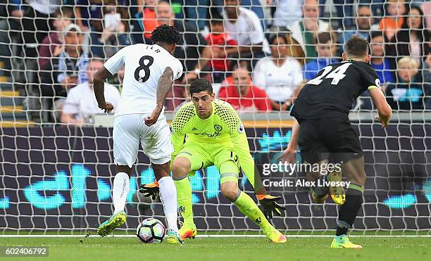 Leroy Fer of Swansea City beats goalkeeper Thibaut Courtois and Gary Cahill of Chelsea as he scores their second goal during the Premier League match...