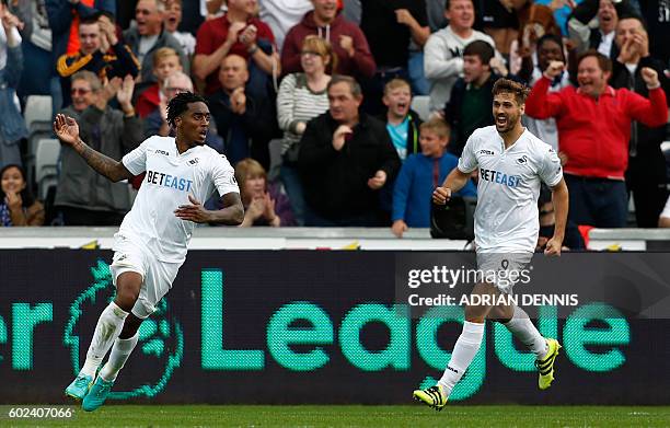 Swansea City's Dutch midfielder Leroy Fer celebrates with Swansea City's Spanish striker Fernando Llorente after scoring their second goal during the...