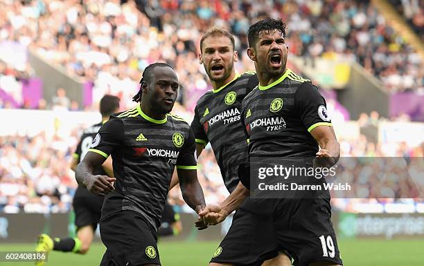 Diego Costa of Chelsea celebrates with team mates Victor Moses and Branislav Ivanovic as he scores their second goal during the Premier League match...