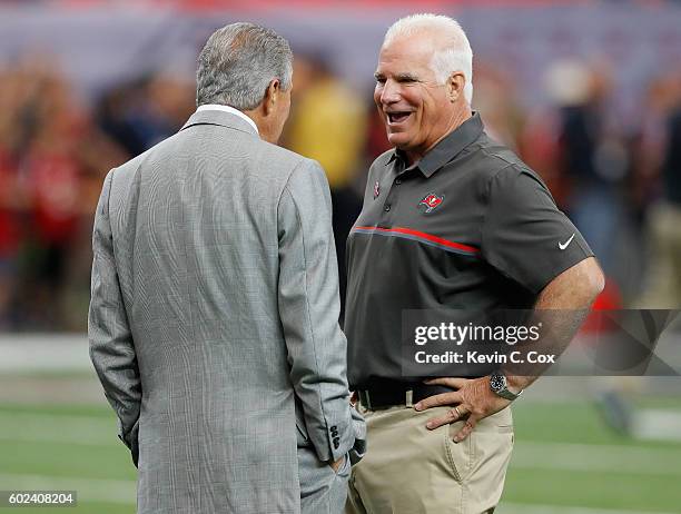 Team Owner Arthur Blank of the Atlanta Falcons and Mike Smith, defensive coordinator for the Tampa Bay Buccaneers converse during pregame warmups at...