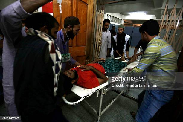 An injured Kashmiri man is brought for treatment to a hospital, on September 11, 2016 in Srinagar, India. 78 civilians have been killed and more than...