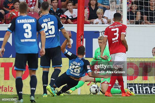 Adam Szalai of Hoffenheim scores his team's fourth goal against goalkeeper Jonas Loessl of Mainz during the Bundesliga match between 1. FSV Mainz 05...