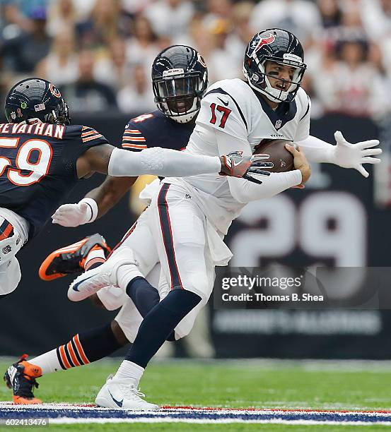 Brock Osweiler of the Houston Texans breaks the tackle of Danny Trevathan of the Chicago Bears in the first quarter at NRG Stadium on September 11,...