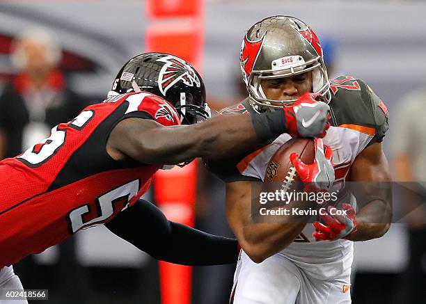 Sean Weatherspoon of the Atlanta Falcons tackles Doug Martin of the Tampa Bay Buccaneers at Georgia Dome on September 11, 2016 in Atlanta, Georgia.