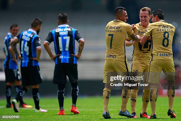 Javier Cortes of Pumas celebrates with teammates after scoring during the 8th round match between Pumas UNAM and Queretaro as part of the Torneo...