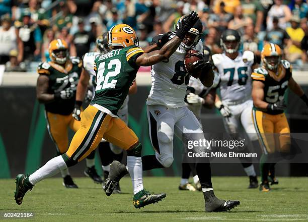 Julius Thomas of the Jacksonville Jaguars tries to elude Morgan Burnett of the Green Bay Packers during their game at EverBank Field on September 11,...