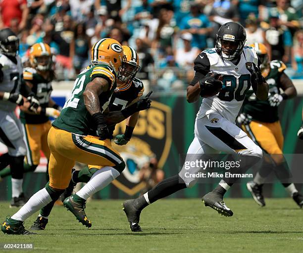 Julius Thomas of the Jacksonville Jaguars looks to elude Morgan Burnett of the Green Bay Packers during their game at EverBank Field on September 11,...