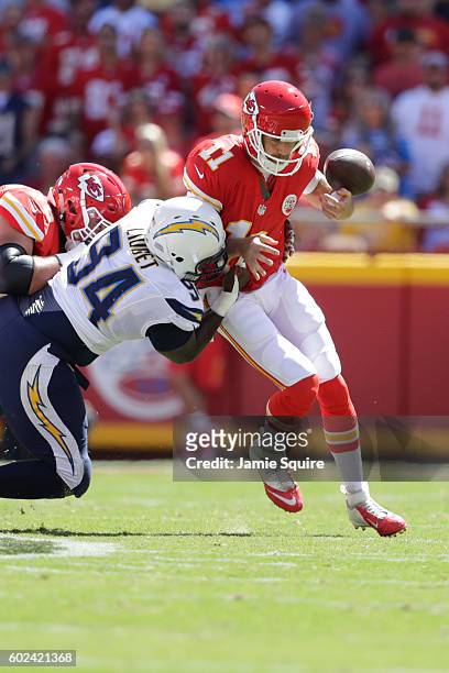 Quarterback Alex Smith of the Kansas City Chiefs fumbles the ball after a hit by defensive end Corey Liuget of the San Diego Chargers during the...