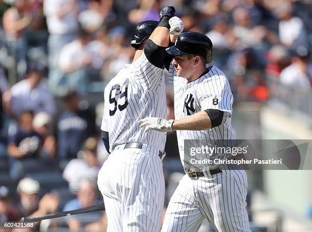 Chase Headley of the New York Yankees is congratulated by Aaron Judge after hitting a solo homerun in the bottom of the fifth inning against the...