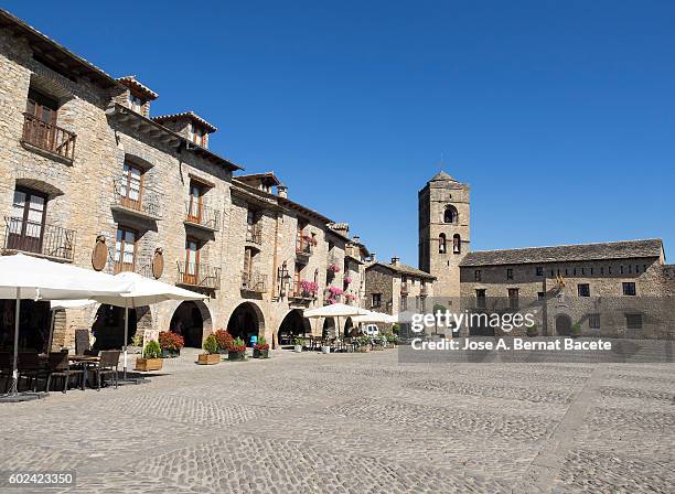 medieval plaza of the people of ainsa with his town hall to the bottom and his church, pyrenees, huesca spain - village street cafe stock pictures, royalty-free photos & images