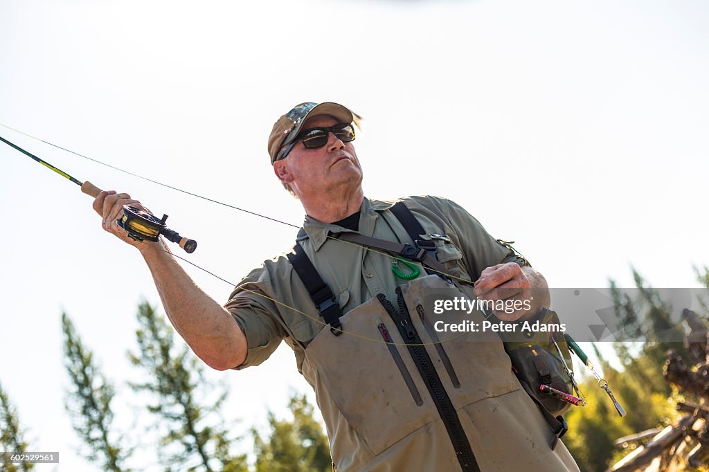 Fly fisherman casting & fishing, British Colombia